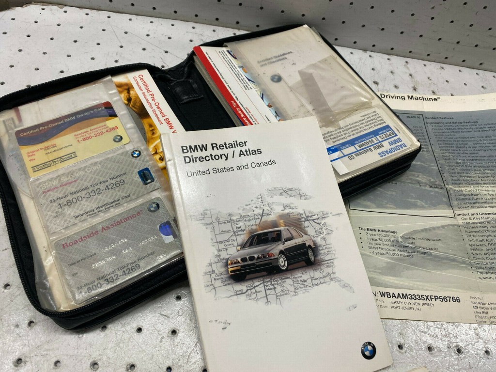 Picture of: BMW i OEM Owner’s Manual Booklet Zippered Binder Original Window  Sticker